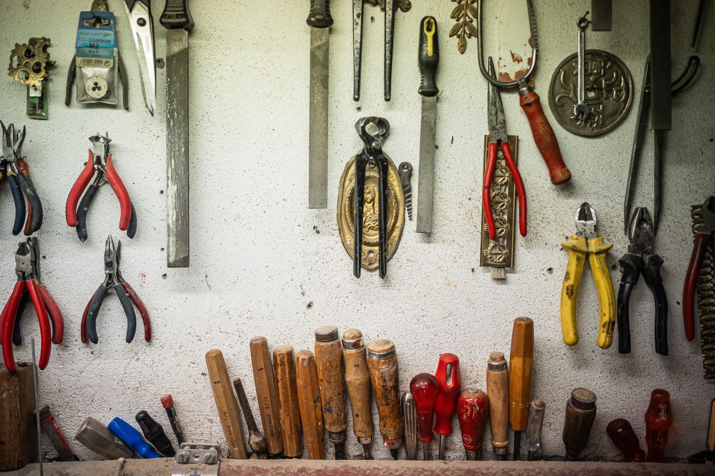 A neatly arranged wall of practical workshop tools